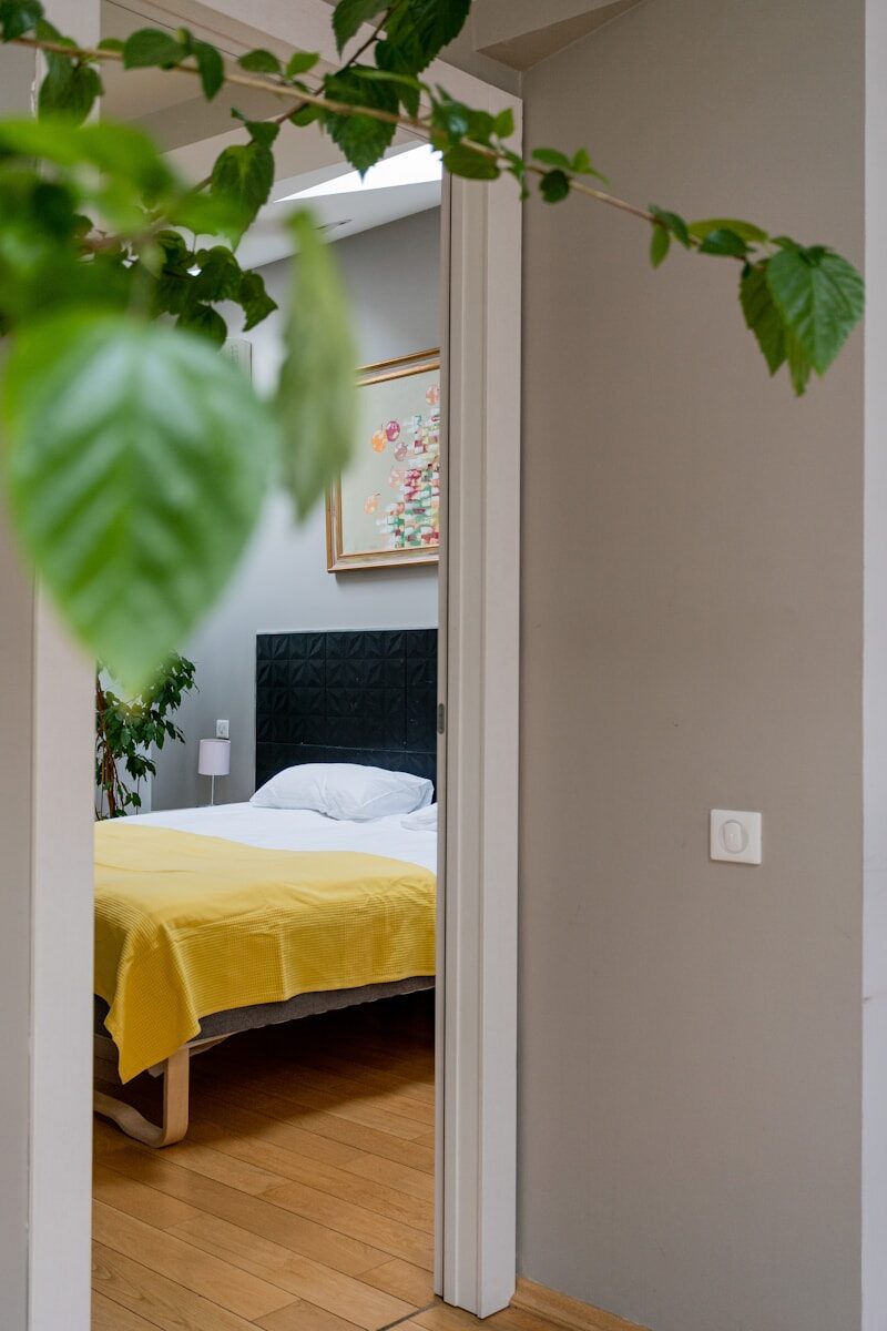 a bed sitting in a bedroom next to a window